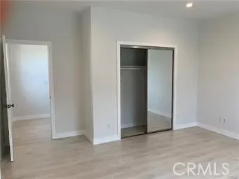 an empty room with closet and a projector