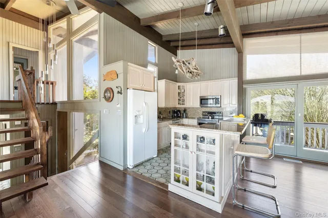 a kitchen with stainless steel appliances granite countertop a refrigerator and a stove