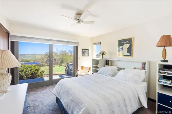 a bedroom with a large bed and a large window
