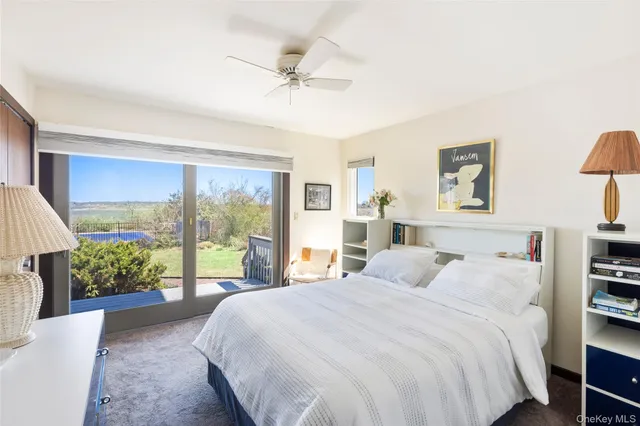 a bedroom with a large bed and a large window
