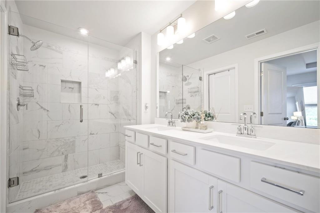1595 Ridgebrook Downs Mableton, GA 30126 - Photo 21 of 39 a bathroom with a shower sink and mirror