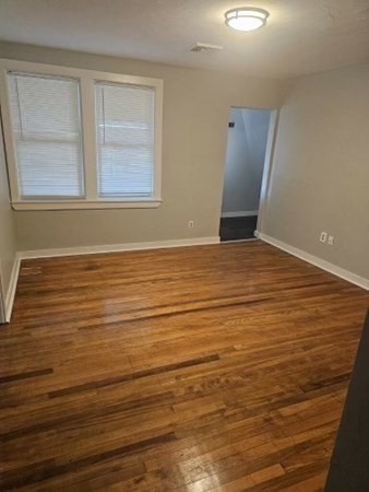 36 Paine Street, Unit 3 Worcester, MA 01605 - Photo 5 of 8 a view of an empty room with wooden floor and a window
