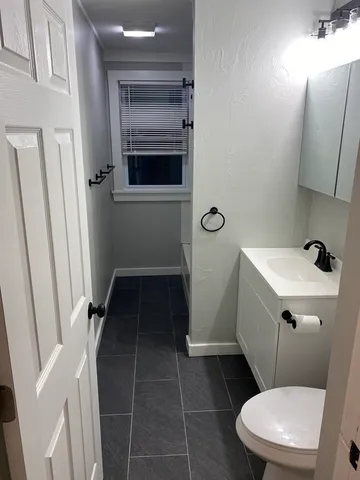 a bathroom with a toilet and a sink