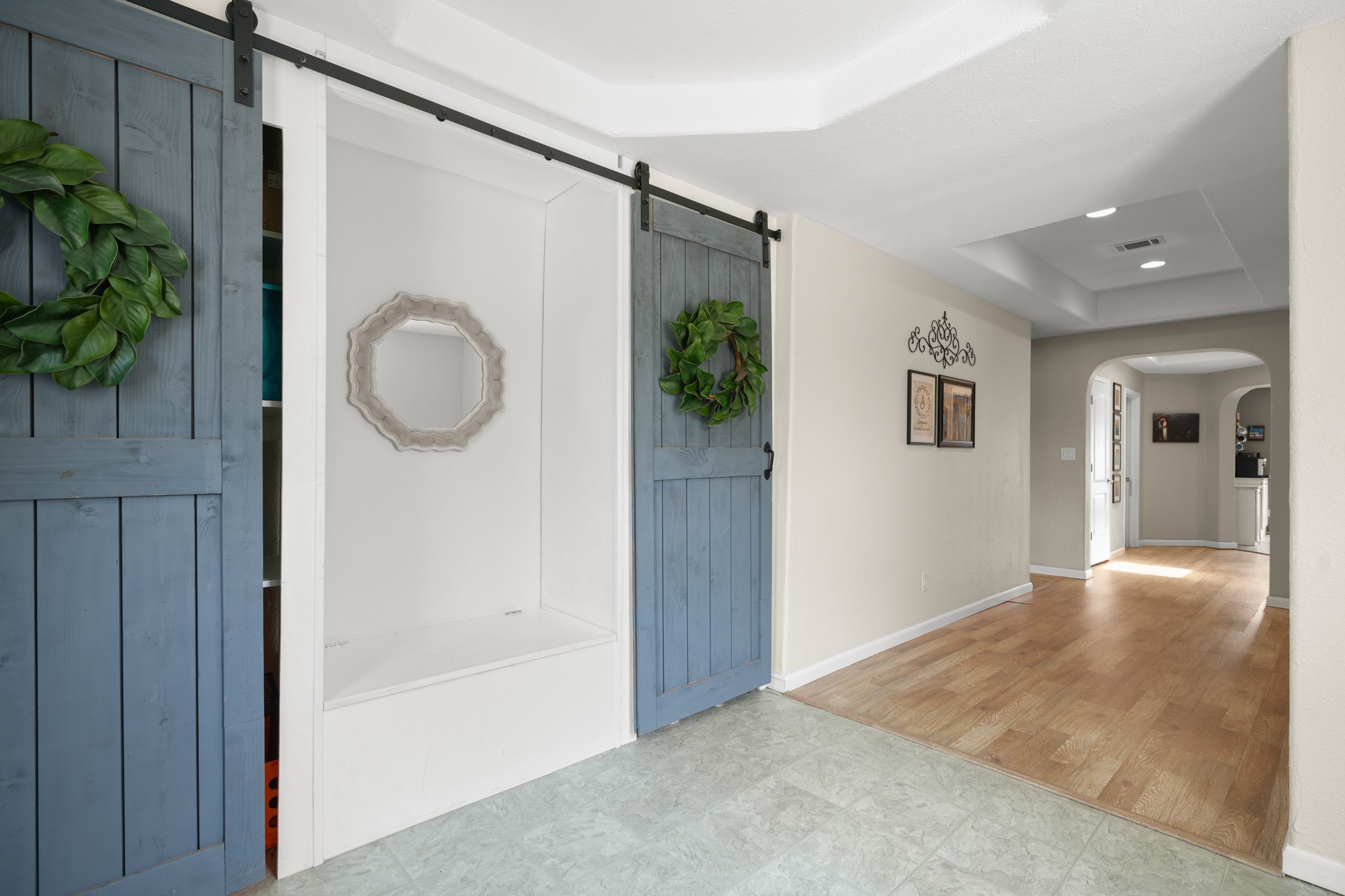 9725 Bock Road Buda, TX 78610 - Photo 3 of 32 Sliding barn doors and varied flooring create a welcoming entry into this home's interior.