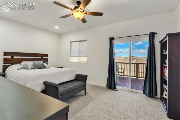 a bedroom with a bed and a ceiling fan