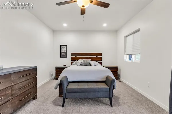 a bedroom with a bed and a dresser
