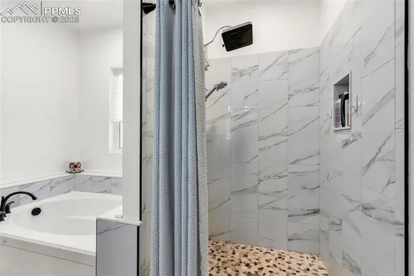 a bathroom with a shower and a sink