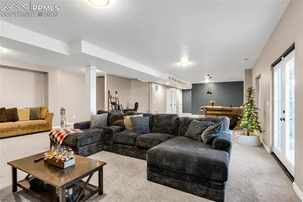 a living room with furniture a rug and a window