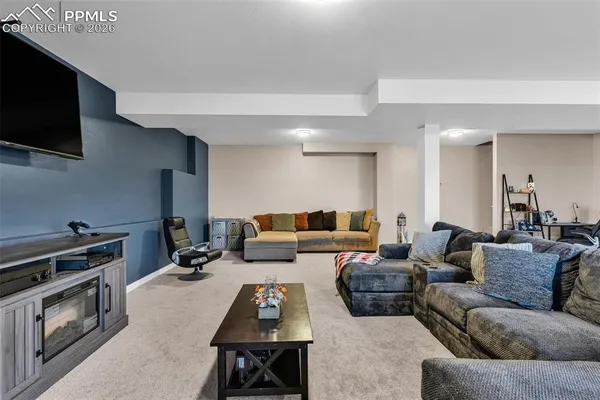 a living room with furniture and a flat screen tv