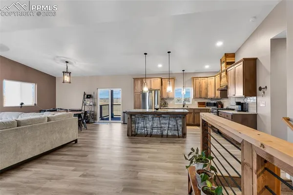 a large white kitchen with a large window and stainless steel appliances