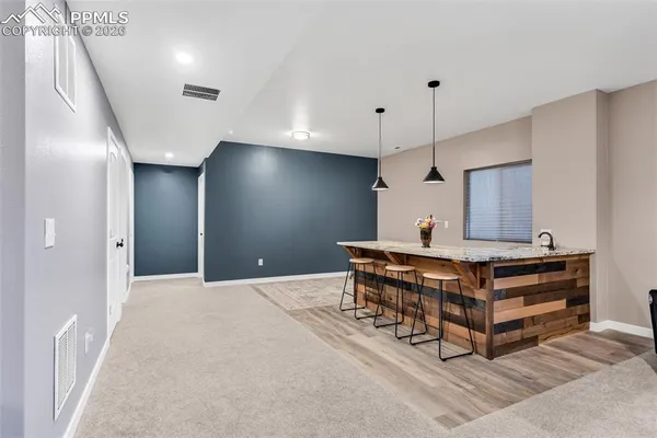 a view of kitchen with furniture and a refrigerator