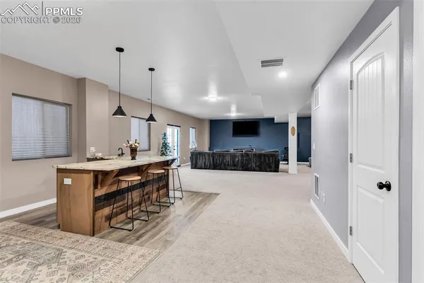 a large kitchen with a table and chairs in it