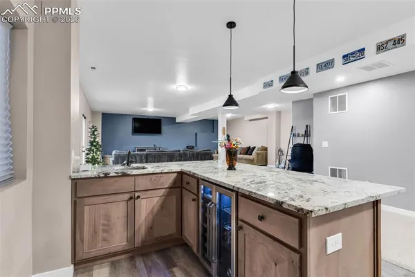 a kitchen with a sink a counter space appliances and cabinets