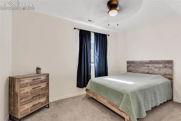 a bedroom with a bed and cabinets