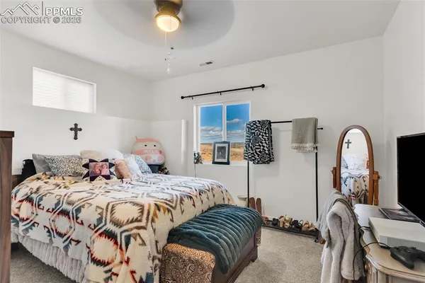 a bedroom with two beds and a dresser