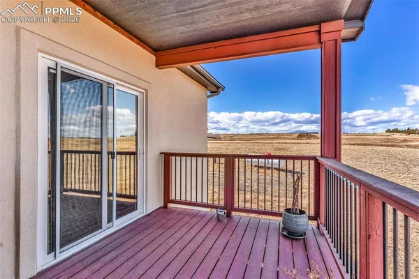 a view of a balcony with wooden floor
