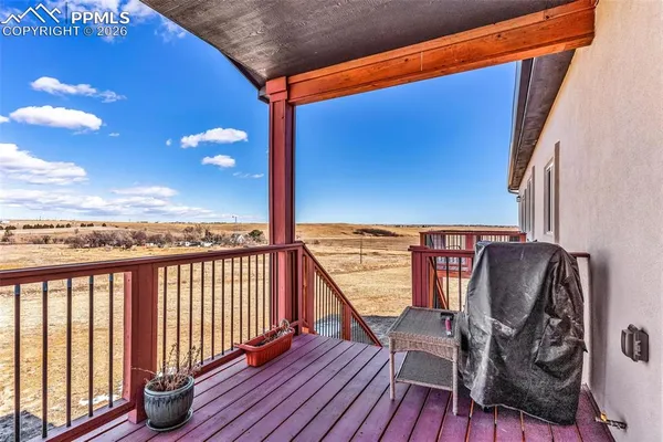 a view of balcony with wooden floor and chair