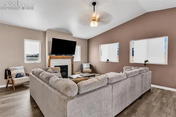 a living room with furniture a fireplace and a flat screen tv