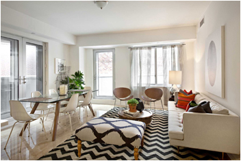a living room with furniture and floor to ceiling windows