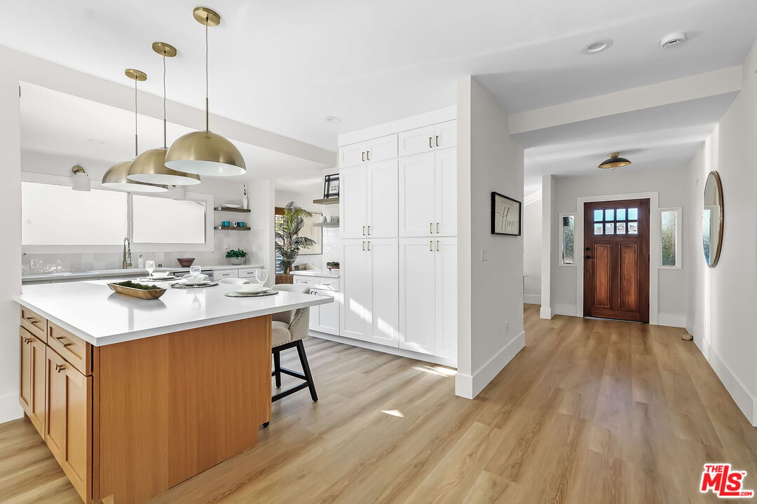 3492 Cabrillo Boulevard Los Angeles, CA 90066 - Photo 15 of 59 a kitchen with kitchen island a sink stove and wooden floor