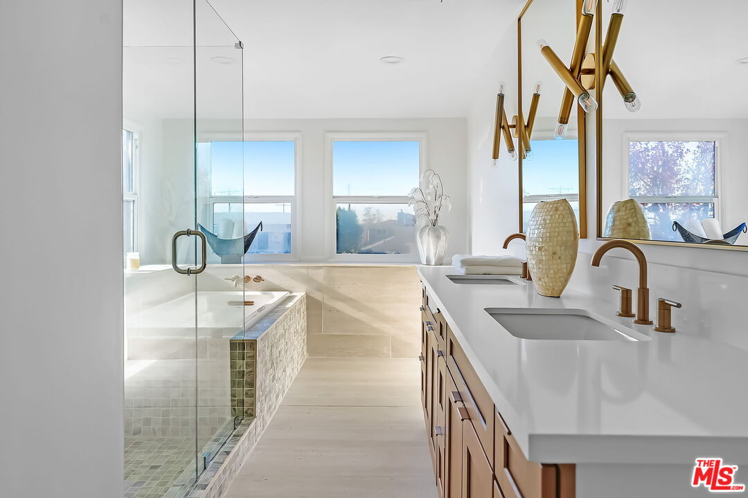 3492 Cabrillo Boulevard Los Angeles, CA 90066 - Photo 40 of 59 a spacious bathroom with a double vanity sink a mirror and a bathtub