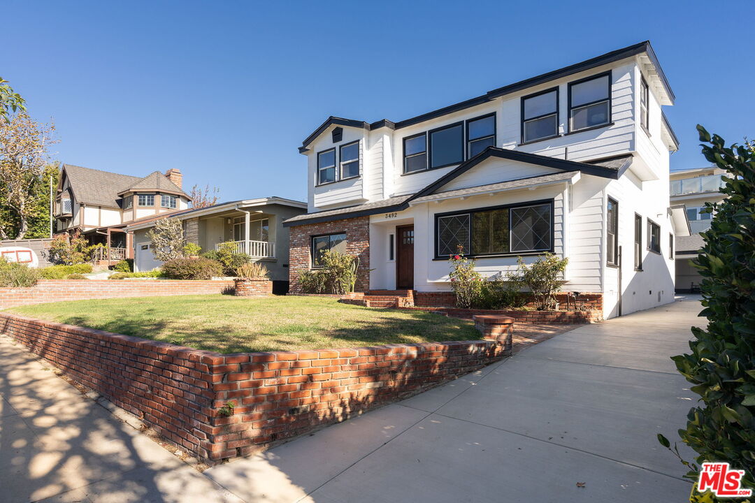 3492 Cabrillo Boulevard Los Angeles, CA 90066 - Photo 49 of 59 a front view of a house with a yard outdoor seating and garage