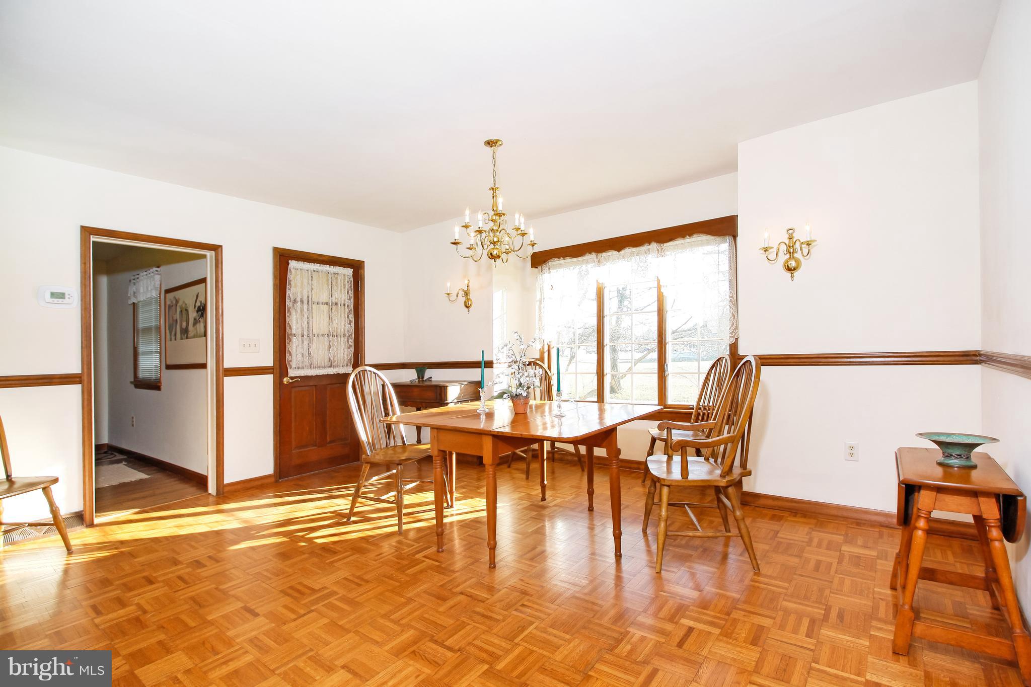 401 Georgetown Road Glassboro, NJ 08028 - Photo 17 of 64 a dining room with furniture a chandelier and wooden floor