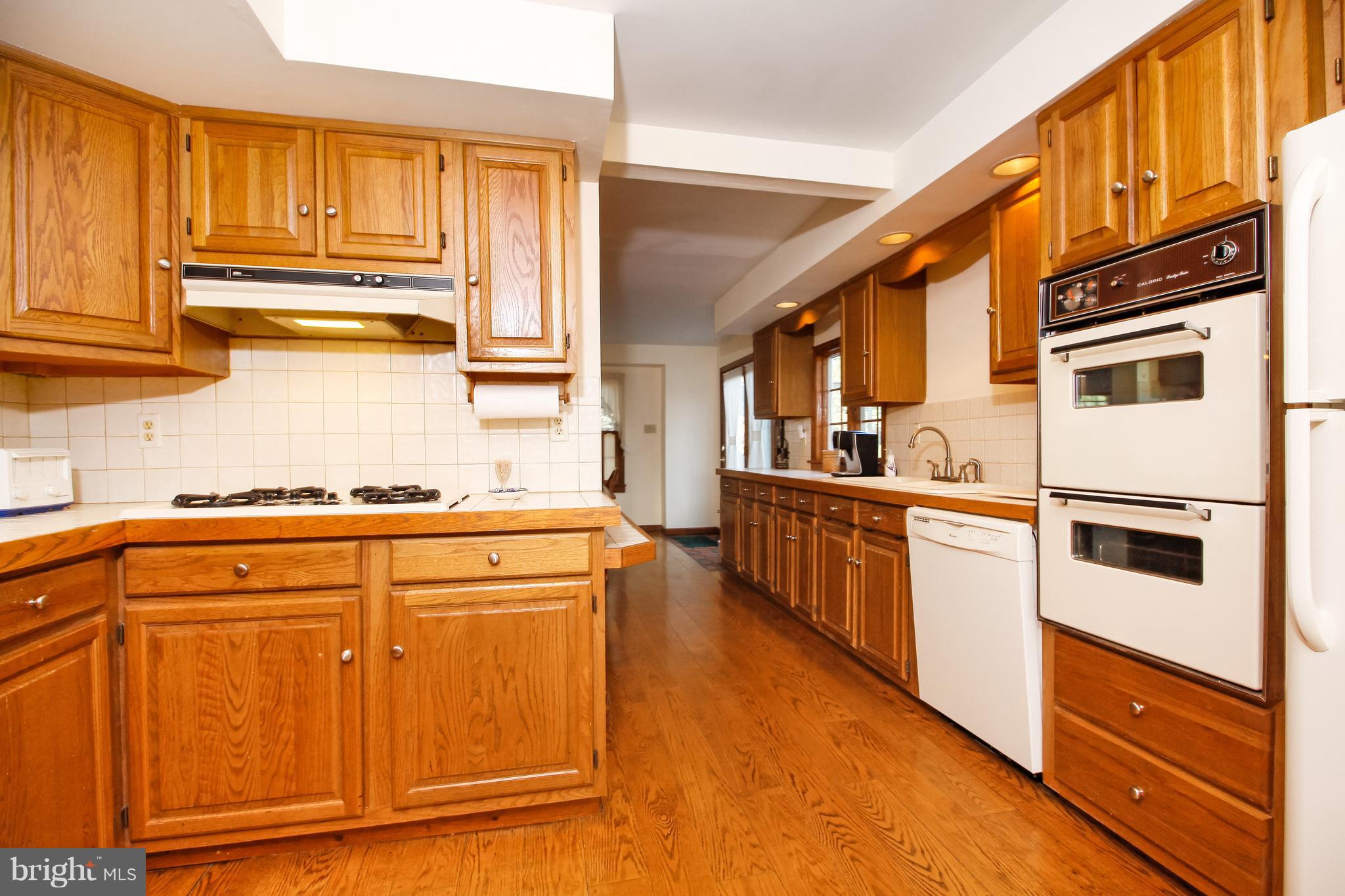401 Georgetown Road Glassboro, NJ 08028 - Photo 26 of 64 a kitchen with stainless steel appliances granite countertop a refrigerator and a stove top oven