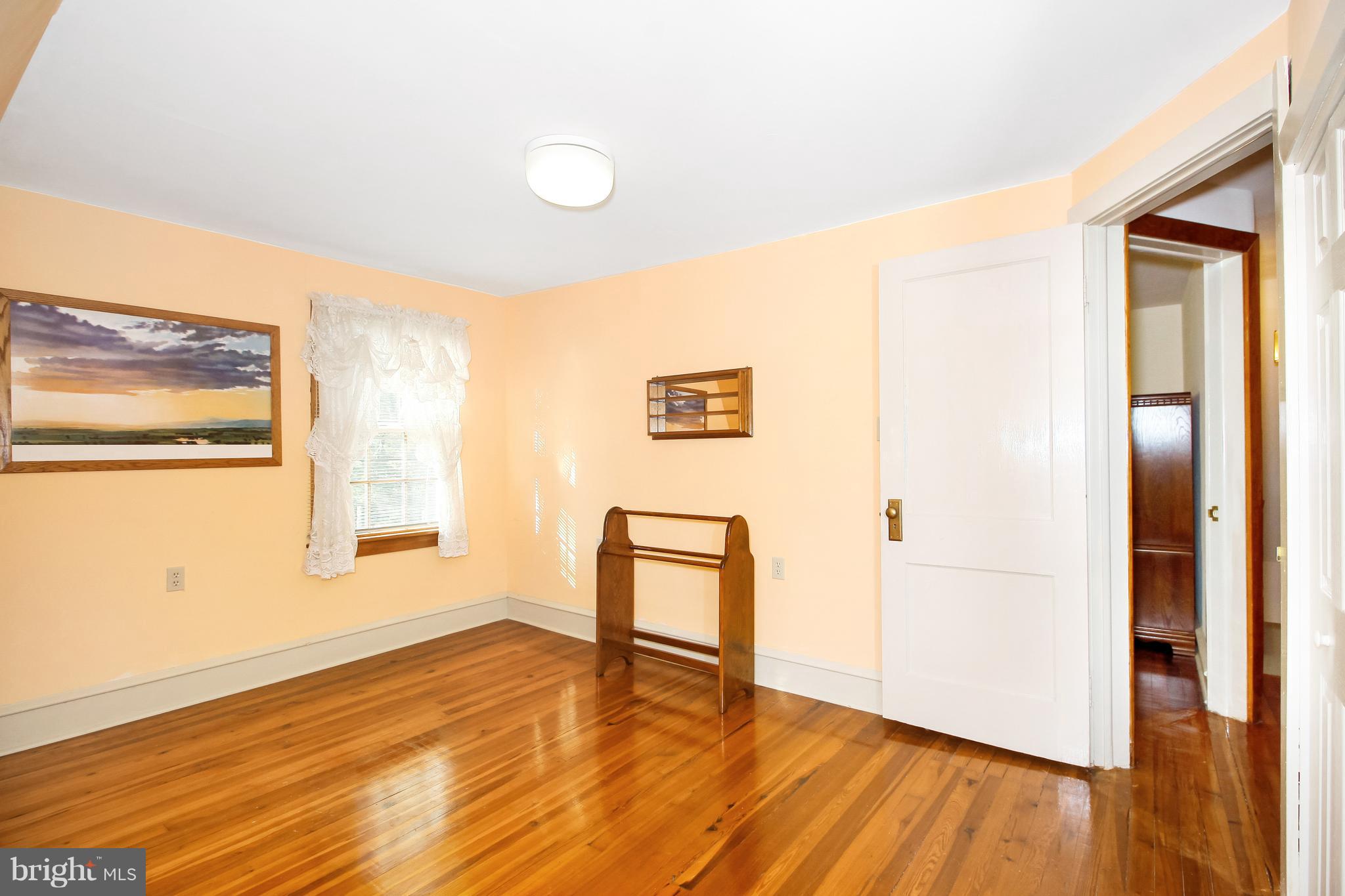 401 Georgetown Road Glassboro, NJ 08028 - Photo 50 of 64 a view of an empty room with wooden floor and a window