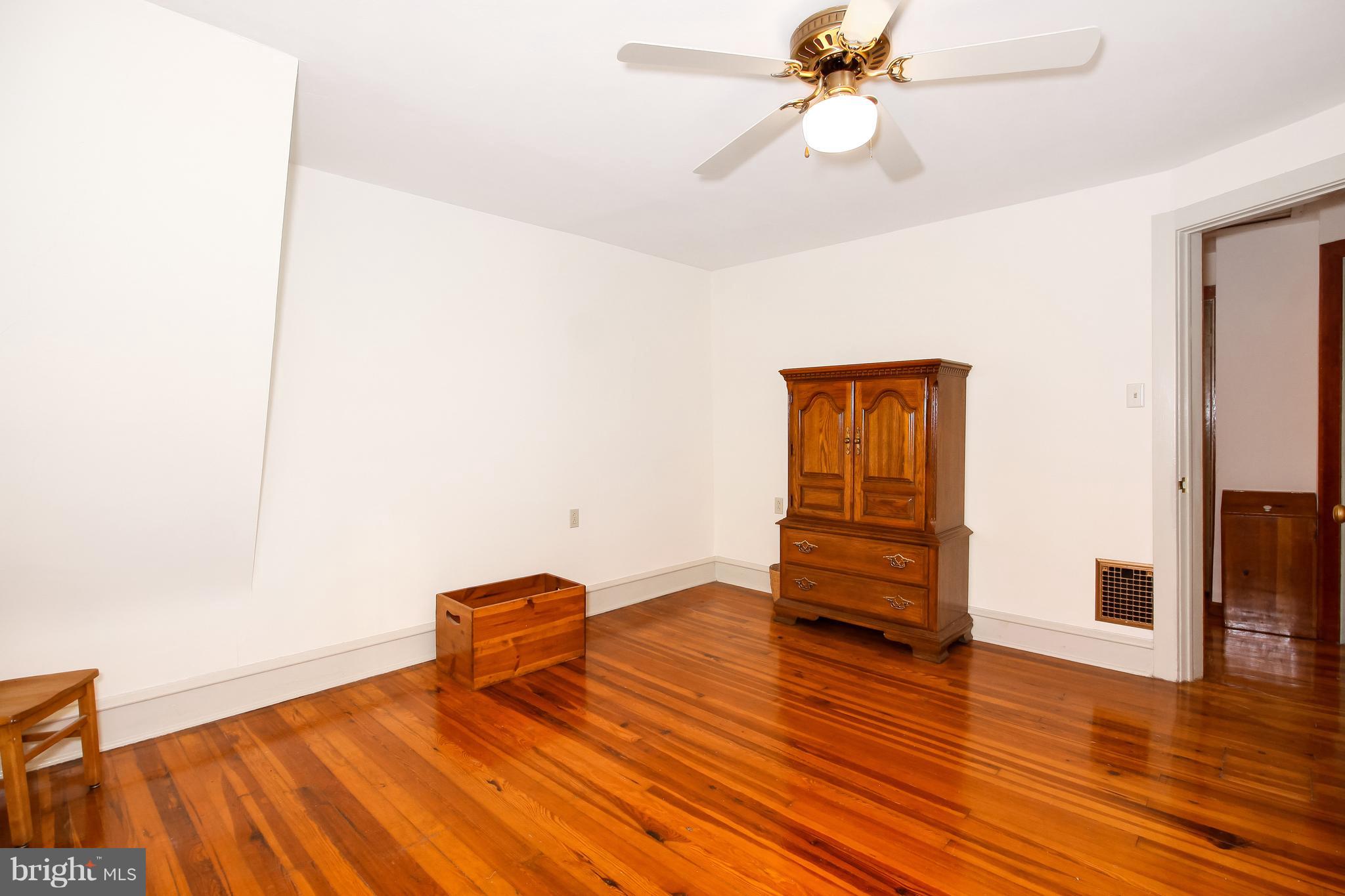 401 Georgetown Road Glassboro, NJ 08028 - Photo 54 of 64 a bedroom with a bed and wooden floor