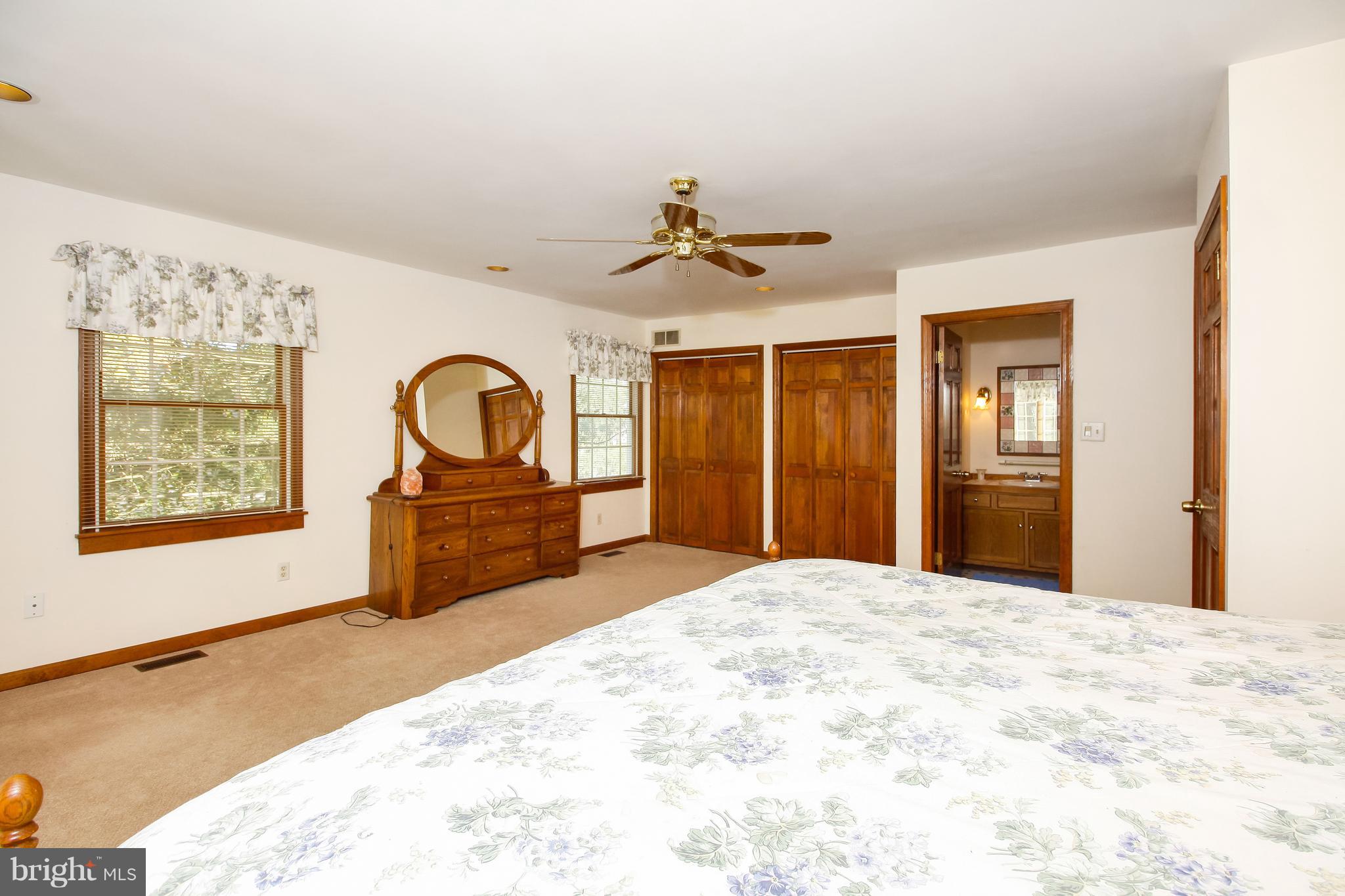 401 Georgetown Road Glassboro, NJ 08028 - Photo 64 of 64 a bedroom with a bed and a dresser with mirror