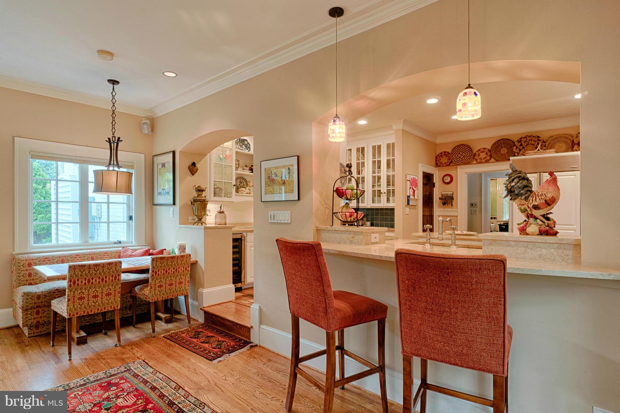 3615 North Glebe Road Arlington, VA 22207 - Photo 10 of 30 a dining room with stainless steel appliances kitchen island granite countertop a table chairs and a chandelier