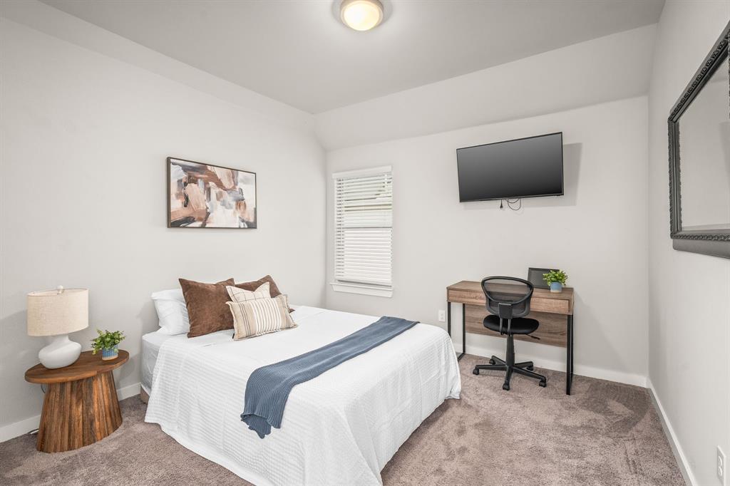 4017 Mapleleaf Pass Melissa, TX 75454 - Photo 22 of 32 a bedroom with a bed and a flat screen tv