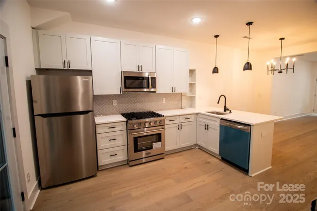 a kitchen with stainless steel appliances a refrigerator sink and cabinets