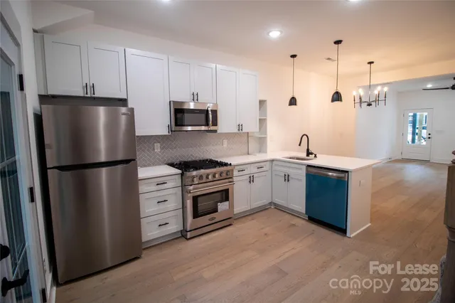 a kitchen with stainless steel appliances a refrigerator sink and cabinets