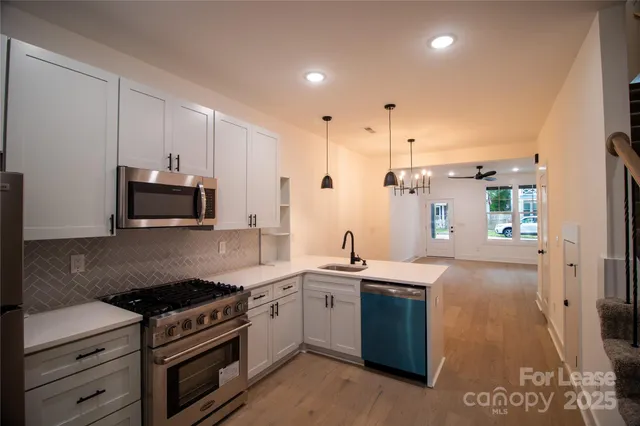 a kitchen that has a sink and a stove
