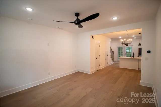 a view of a livingroom with a ceiling fan & entryway