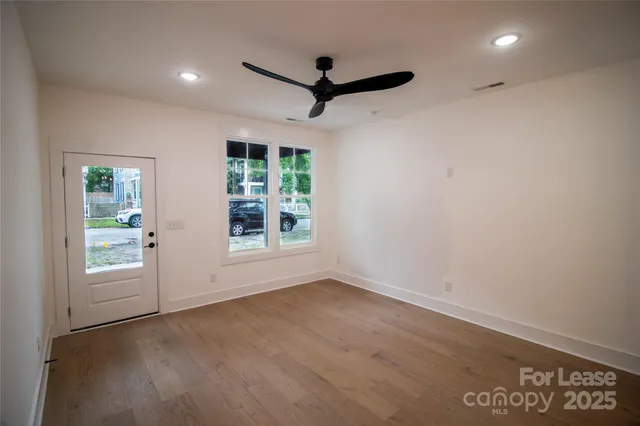 a view of room window and a ceiling fan