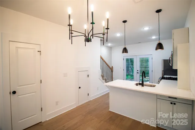 a kitchen with stainless steel appliances kitchen island a large island a sink a window and a counter top space