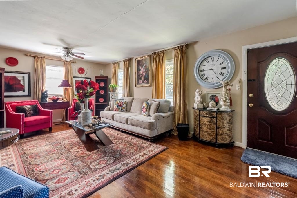 109 Esplanade Avenue Mobile, AL 36606 - Photo 4 of 45 Living area featuring dark wood-type flooring, healthy amount of natural light, and a ceiling fan
