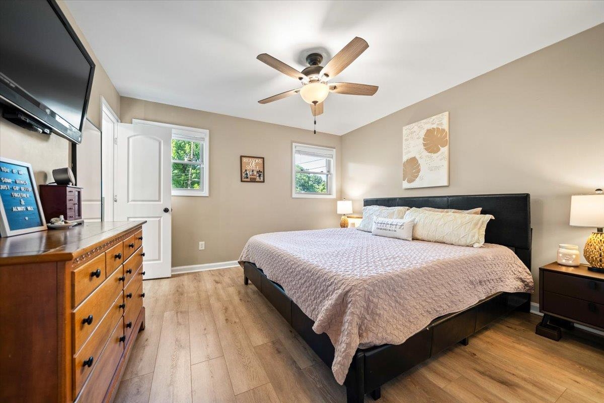 4686 Bill Knight Road Millington, TN 38053 - Photo 16 of 29 Bedroom featuring wood-finish flooring, neutral wall tones, and white trim