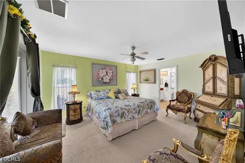a bedroom with a bed couch and a window
