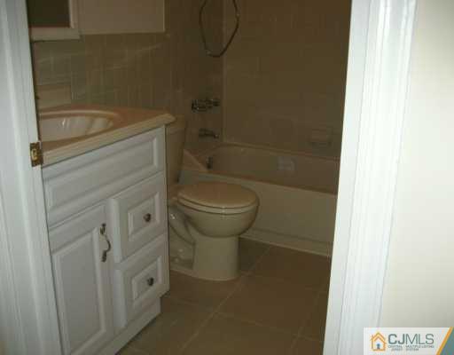 1943 Raspberry Court Edison, NJ 08817 - Photo 3 of 4 a bathroom with a granite countertop toilet and a sink