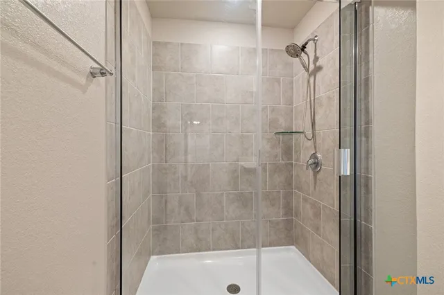 a bathroom with a shower and a bathtub