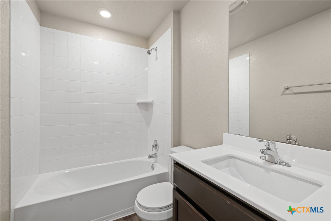 922 Stone Vly Road Temple, TX 76502 - Photo 18 of 32 a bathroom with a granite countertop sink toilet a mirror and shower