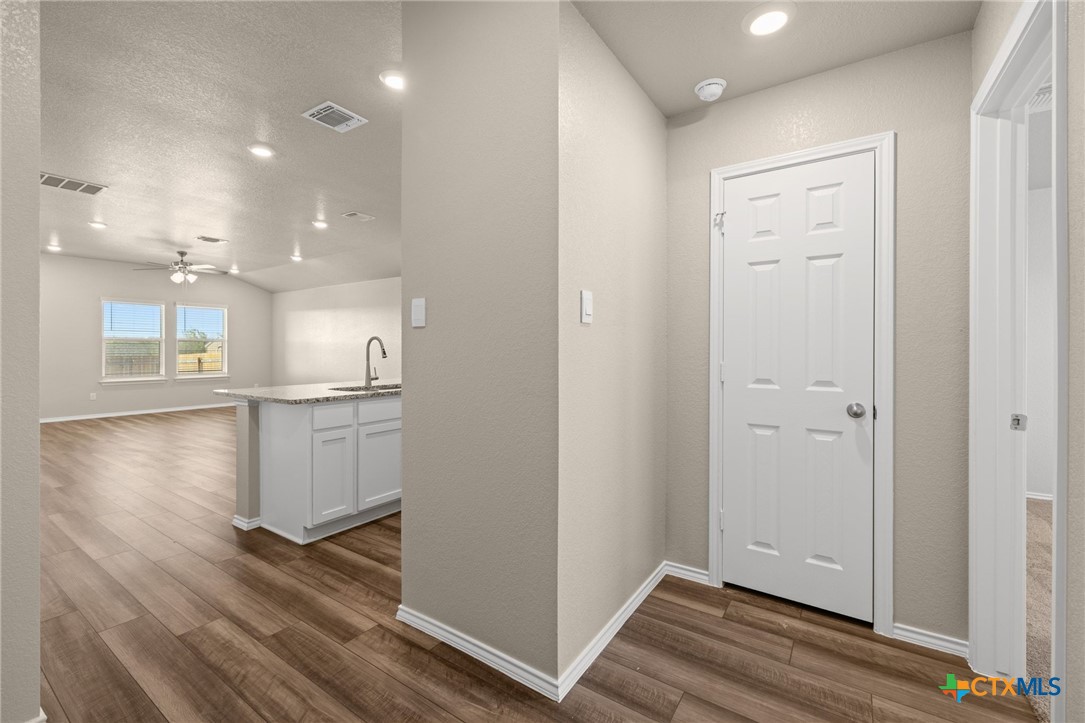 922 Stone Vly Road Temple, TX 76502 - Photo 20 of 32 a view of kitchen and empty room with wooden floor