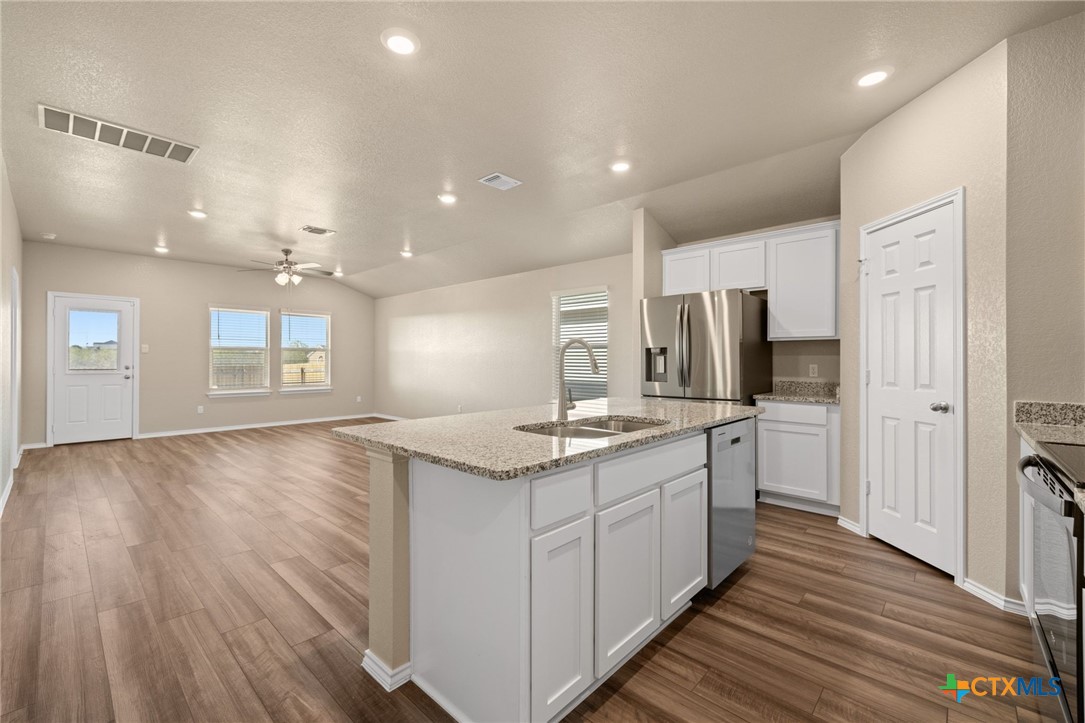 922 Stone Vly Road Temple, TX 76502 - Photo 21 of 32 a kitchen with stainless steel appliances granite countertop a sink and cabinets