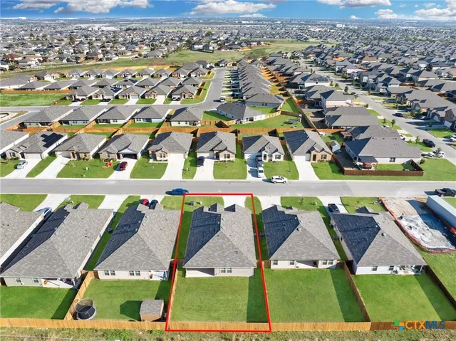 an aerial view of residential houses with outdoor space