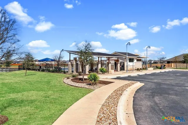 a swimming pool with outdoor seating and yard