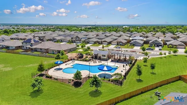 a view of a swimming pool with a yard